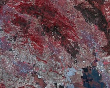 Fire scar on the Northern California landscape. This image, acquired October 21, 2017 by NASA's ASTER  instrument, depicts vegetation in red, while burned areas appear dark gray.